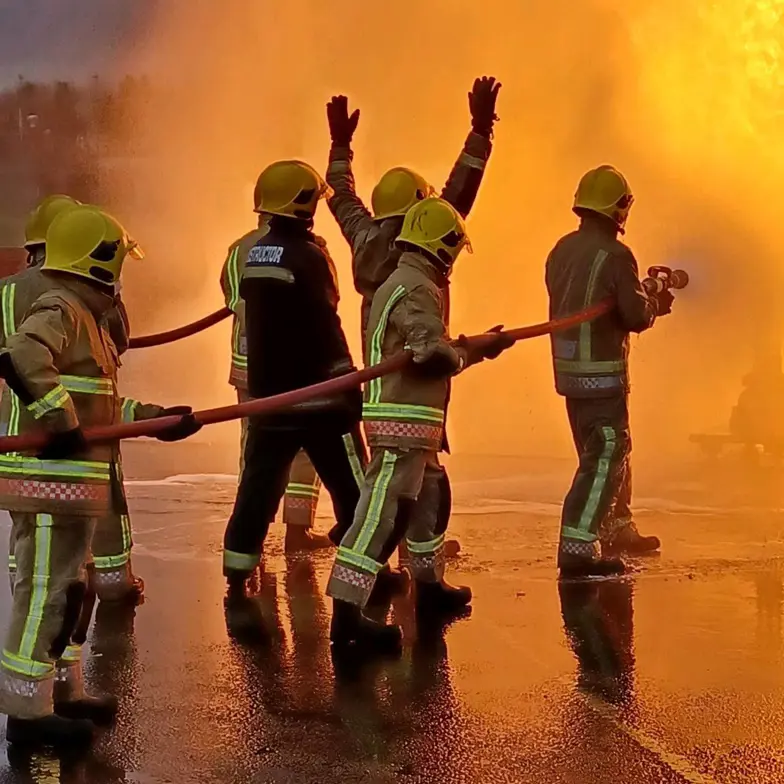 Delegate Team With Hose Dousing Fire